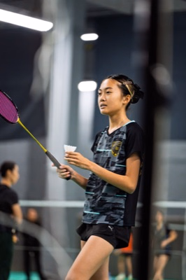 Badminton Ontario Junior A player holding a shuttlecock before serving