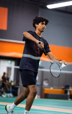 Badminton Ontario Junior A player preparing a serve at the net