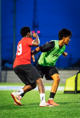 Lakeshore United players duelling under floodlights