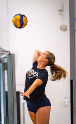 Volleyball player tossing the ball to serve