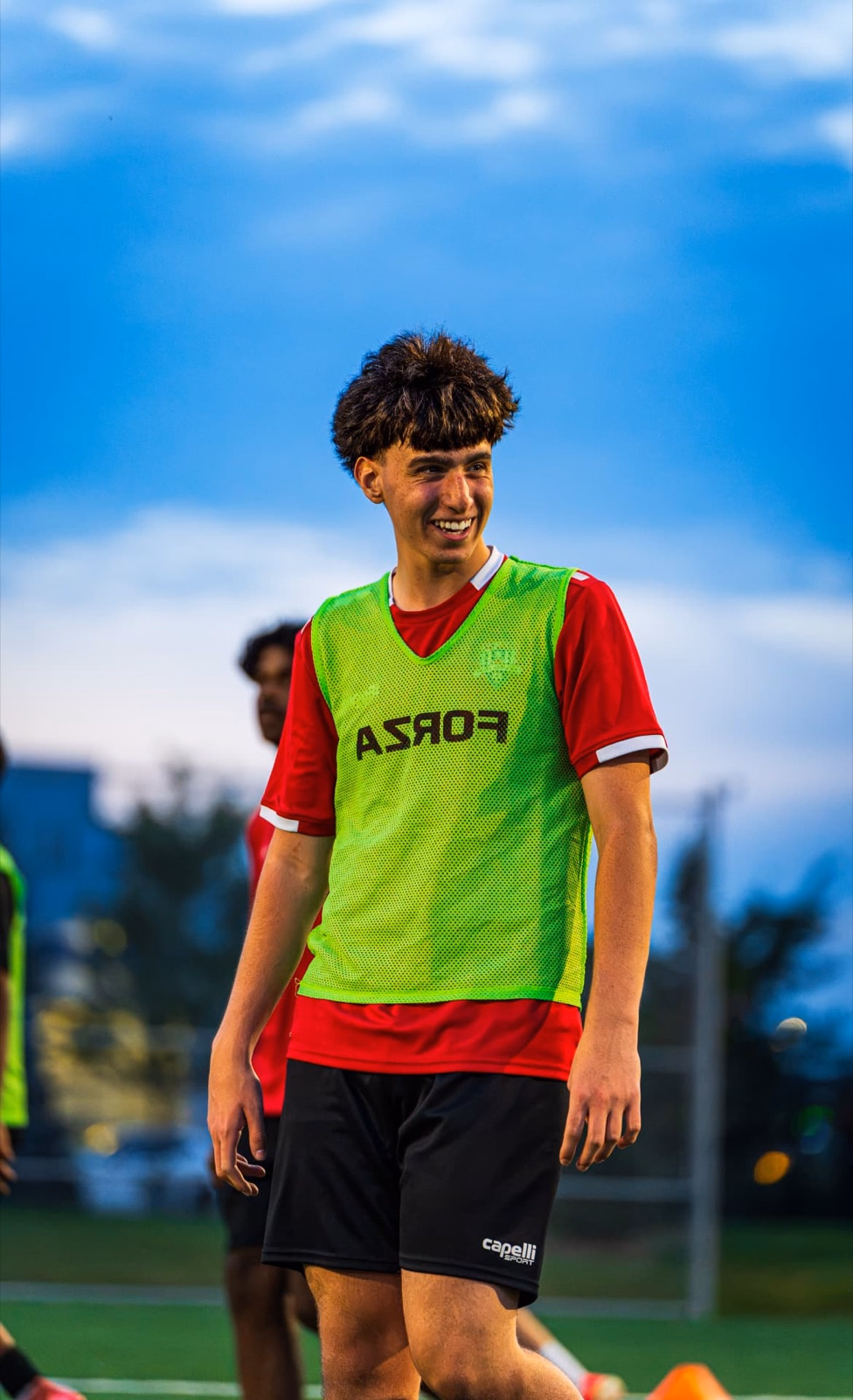 Pro Stars FC player smiling during an evening training session